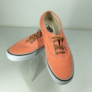 Vans lace up men’s orange salmon colored shoes.